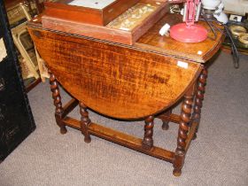 An oak barley twist gate leg table