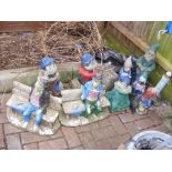 Assorted garden gnomes and ornaments, some painted