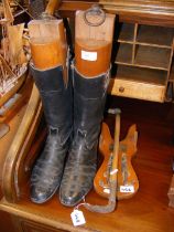 Black leather riding boots, together with wooden s
