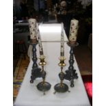 A pair of pewter candlesticks together with a pair