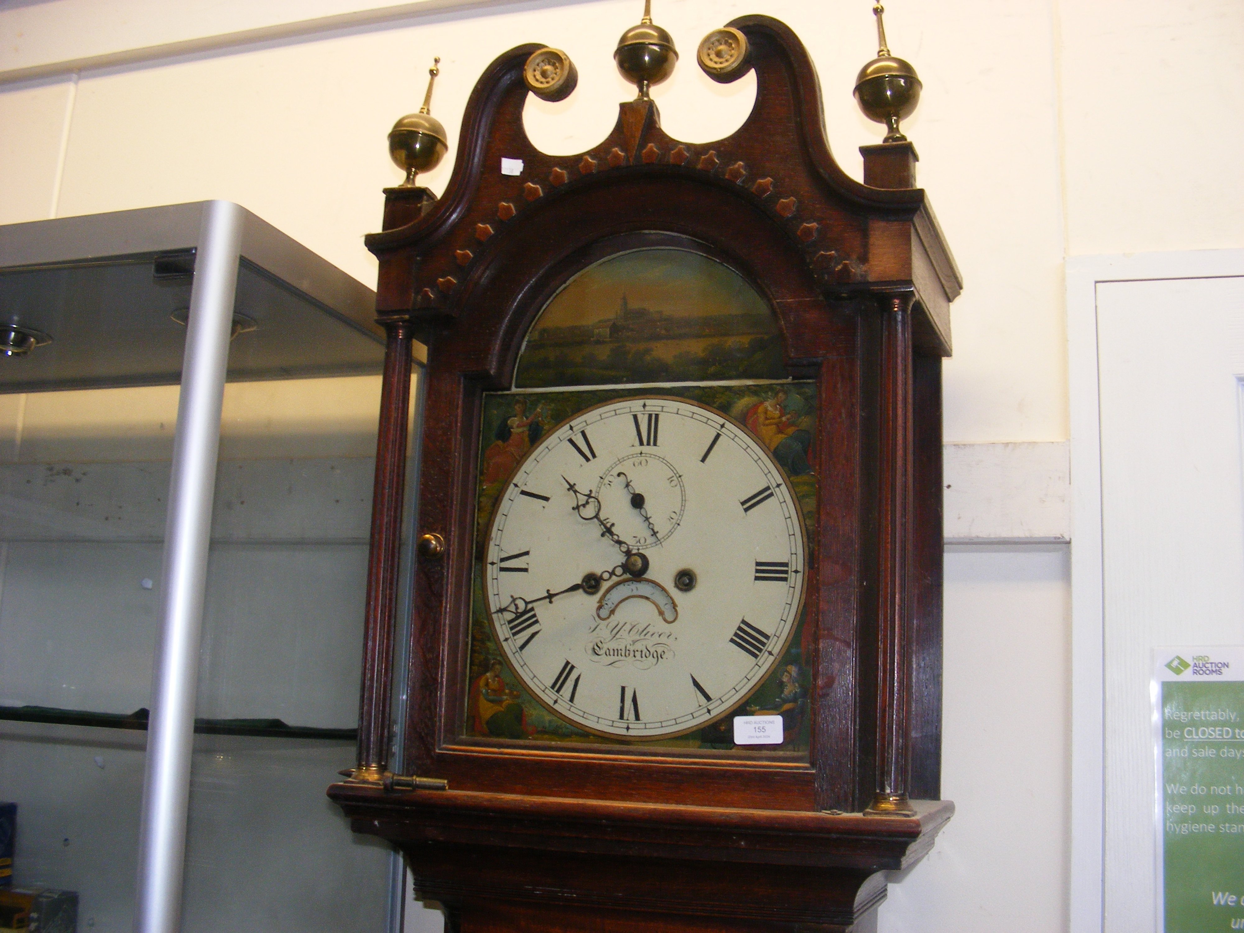 An antique oak long case clock with painted arch d