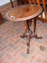 A 19th century wine table with carved top and base