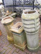 Three chimney pots of varying shape and size