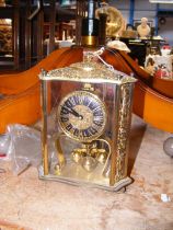 A decorative gilt cased mantel clock