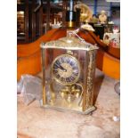 A decorative gilt cased mantel clock