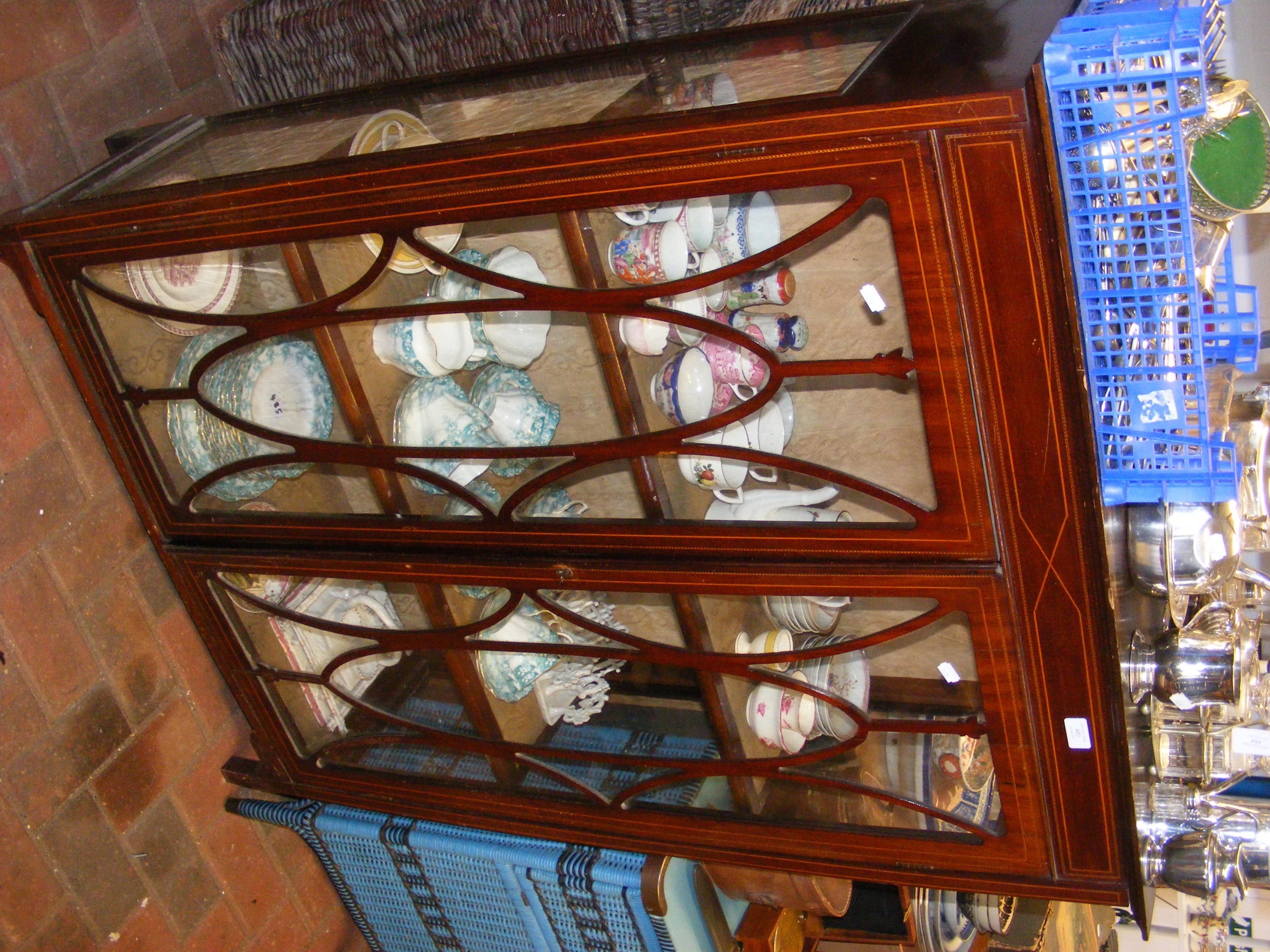 An antique display cabinet, with two shelves to th