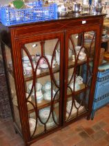 An antique display cabinet, with two shelves to th