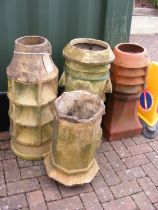 Four chimney pots of varying shape and size