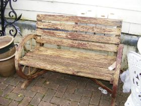 A wooden 2 seater wagon wheel outdoor garden patio bench - length 106cm