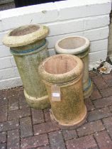 Three chimney pots of varying shape and size