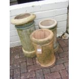 Three chimney pots of varying shape and size