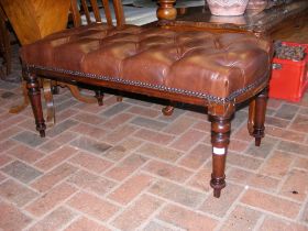 A duet stool, upholstered in button brown leather