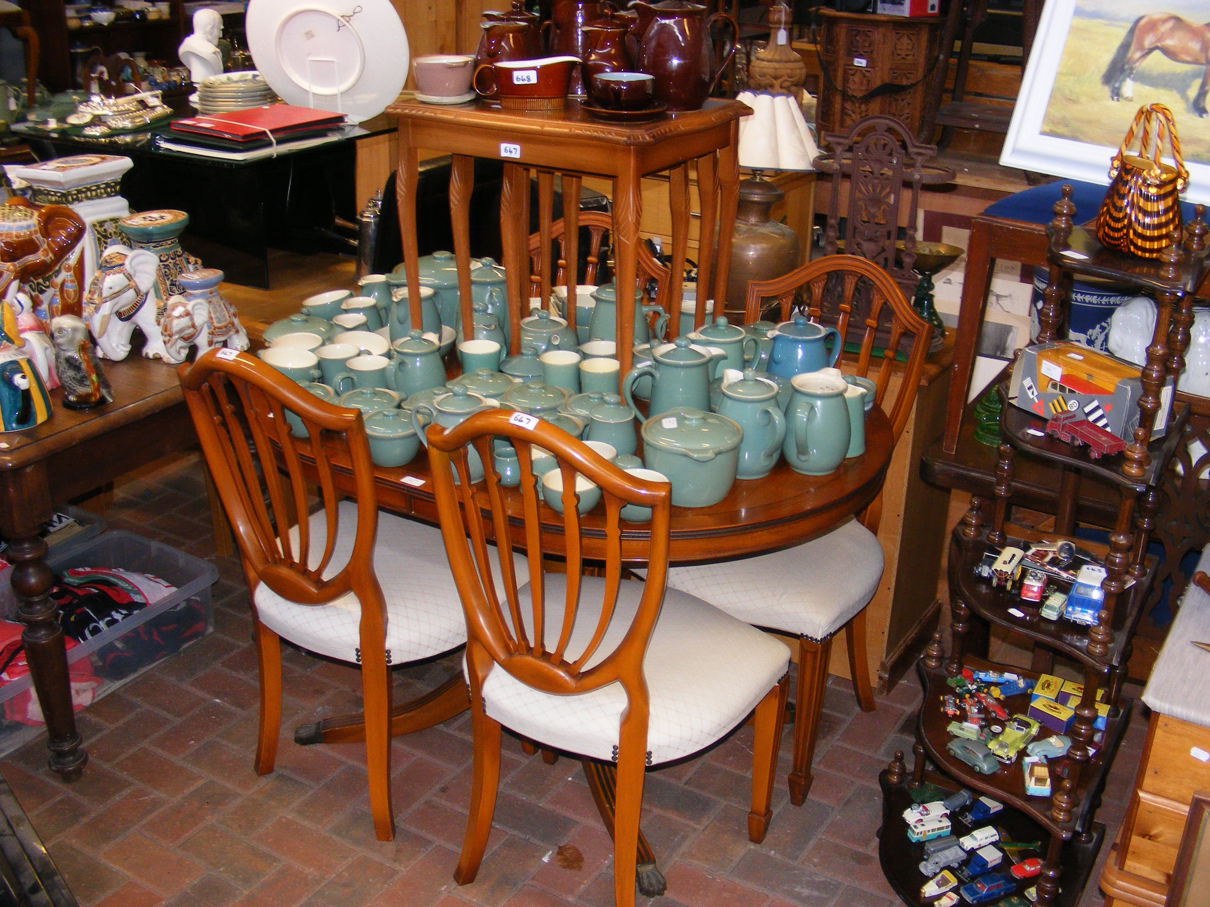 A Maples yew wood extending dining table and four