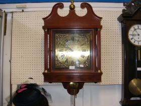 A reproduction antique style wall clock with two b