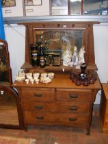 An oak dressing chest with swing mirror to back -