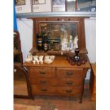 An oak dressing chest with swing mirror to back -