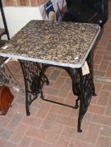 A converted sewing machine table with marble top