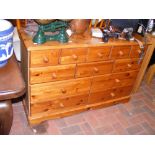 A lacquered pine multi chest of drawers - width 11