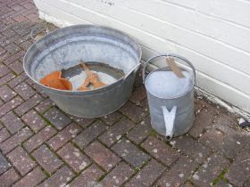 A galvanised metal bath, watering can and other ga