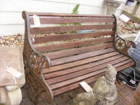 A slatted garden bench with cast iron ends - lengt