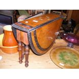 A folding walnut table with inlaid design