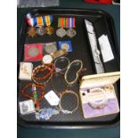 A selection of costume jewellery, medals etc.