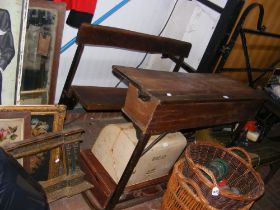 An unusual double seated school desk with lift up