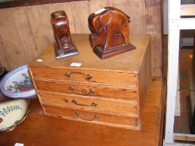 A miniature pine chest of four drawers together wi