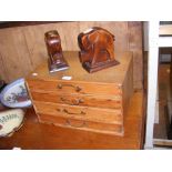 A miniature pine chest of four drawers together wi