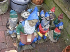 A collection of garden gnomes, some painted