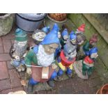 A collection of garden gnomes, some painted