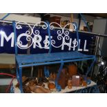 A wrought iron garden bench painted blue and white