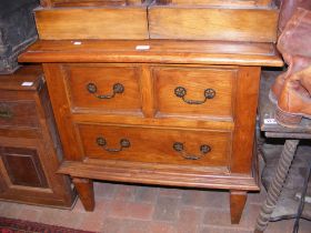 A hardwood chest of two short and one long drawer