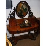 An antique mahogany dressing table with oval swing