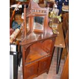 A mahogany corner cupboard with mirrored back