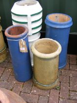 Four chimney pots of varying shape and size - some