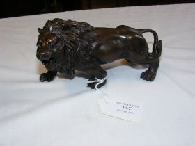 A bronze figure of a lion - length 15cm