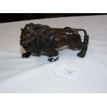 A bronze figure of a lion - length 15cm