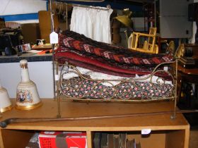 A wire metal framed doll's bed, a woven saddlebag