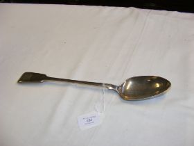 A silver basting spoon