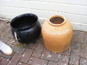 A cast metal cauldron and a terracotta rhubarb for