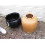 A cast metal cauldron and a terracotta rhubarb for