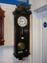 A Vienna regulator style wall clock with single tr