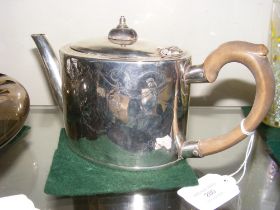 A silver teapot with engraved decoration