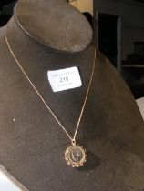 A gilt farthing in 9ct gold mount, with 9ct chain