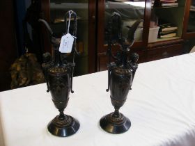 A pair of classical style bronze ewers with figure