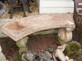 A constituted stone curved garden bench - length 1