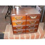 A miniature mahogany chest of eight drawers - widt