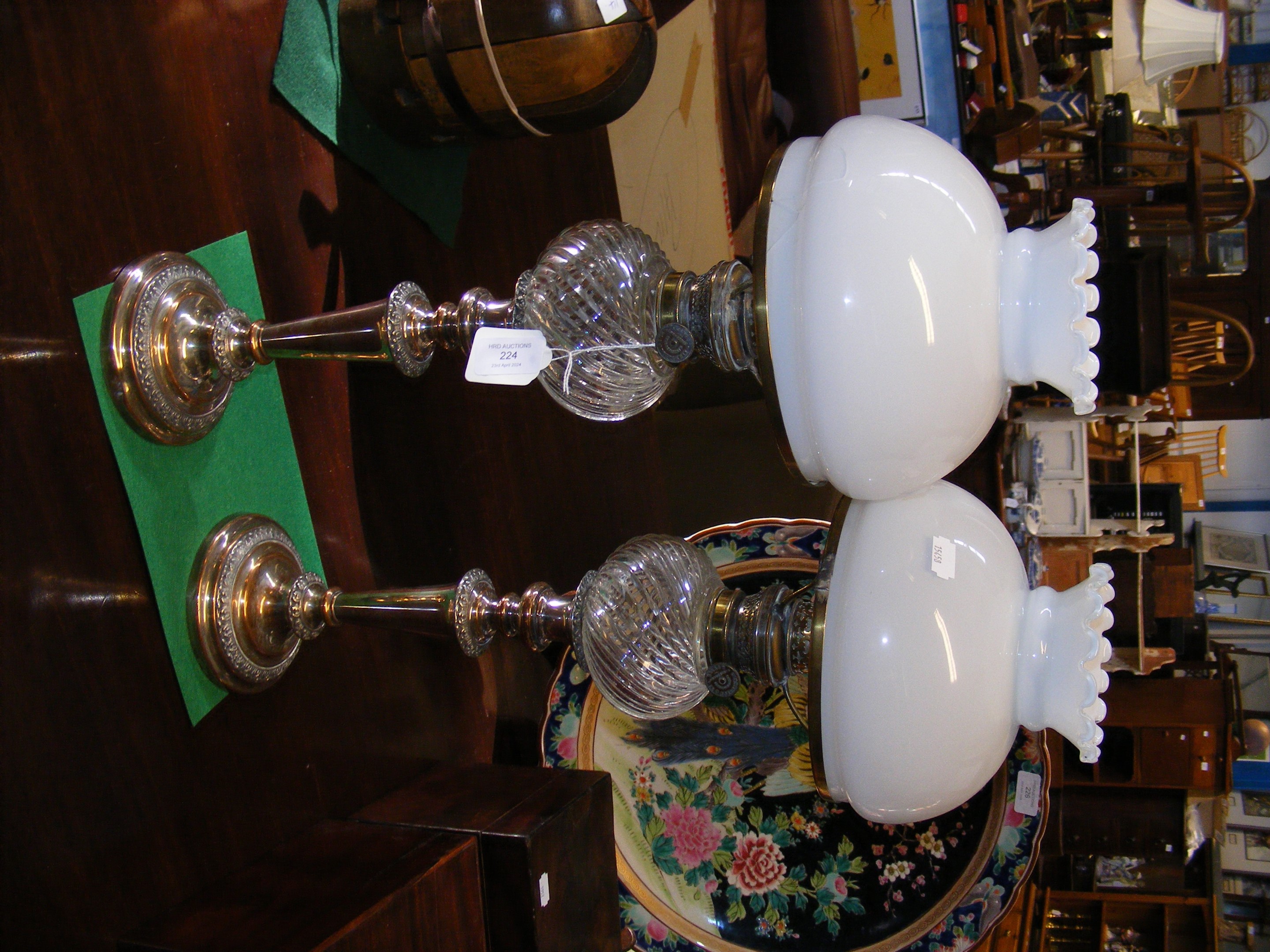 A pair of silver plated and glass oil lamps with Z