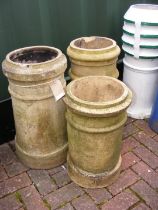Three chimney pots of varying shape and size
